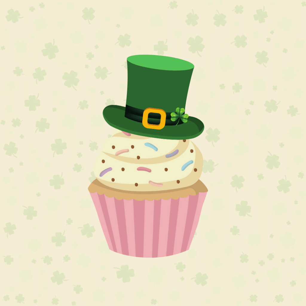 Cupcake with leprechaun hat on plain background with four leaf clovers